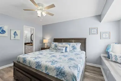 a bedroom with a bed and a ceiling fan at Pet-Friendly Coastal Townhome | Walk to Beach & Local Dining in Panama City Beach