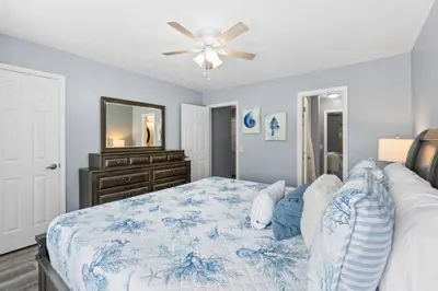 a bedroom with a bed and a ceiling fan at Pet-Friendly Coastal Townhome | Walk to Beach & Local Dining in Panama City Beach