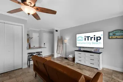 a living room with a couch and a ceiling fan at Pirates Cove Inlet Unit H (0/1) in Panama City Beach