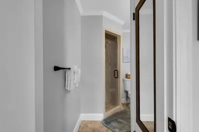 a bathroom with a toilet and a mirror at Pirates Cove Inlet Unit H (0/1) in Panama City Beach