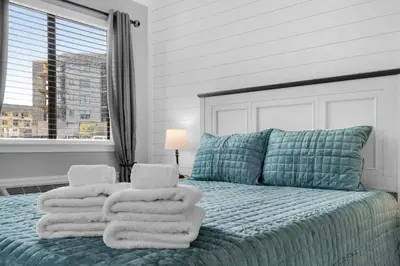 a bedroom with a bed with towels on it at Pirates Cove Inlet Unit H (0/1) in Panama City Beach