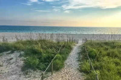 a path to the beach with the ocean in the background at Pirates Cove Inlet Unit H (0/1) in Panama City Beach