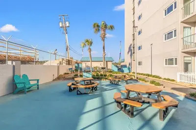 a group of tables and benches on a patio at The Summit 315 in Panama City Beach