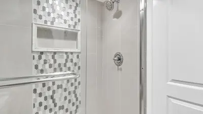 a shower with a glass door in a bathroom at Low Floor - Remodeled - Beachfront - FLPCB65 in Panama City Beach