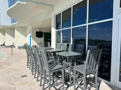 a row of tables and chairs on a patio at Romantic Beachfront Sunsets in Panama City Beach