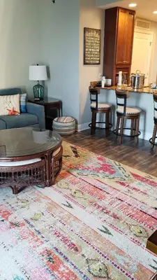 a living room with a couch and a rug at Romantic Beachfront Sunsets in Panama City Beach