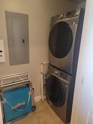 a laundry room with a washer and a washing machine at Romantic Beachfront Sunsets in Panama City Beach