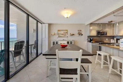 a kitchen with a table and chairs and a counter at Direct Gulf View 2BR Paradise Found in Panama City Beach