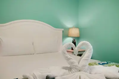 two towel swans sitting on top of a bed at Direct Gulf View 2BR Paradise Found in Panama City Beach