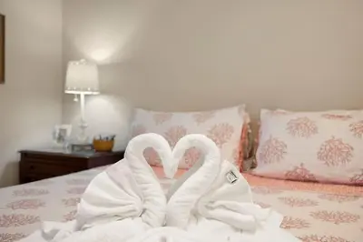 two swans wrapped in towels sitting on a bed at Direct Gulf View 2BR Paradise Found in Panama City Beach