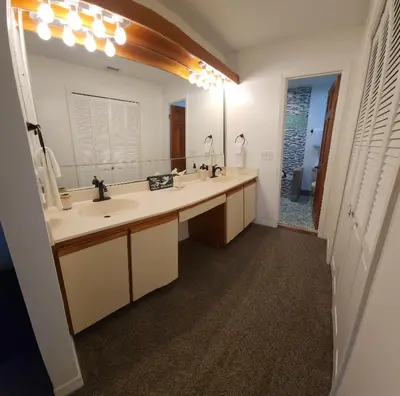 a bathroom with a sink and a large mirror at 3BR Grand Lagoon Front Townhome - Private Dock, Resort Amenities & Beach Walk in Panama City Beach