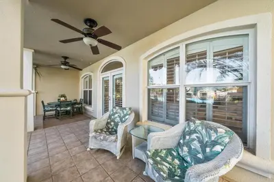 a living room with two chairs and a ceiling fan at Lagoon Lounge in Seacrest