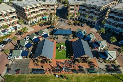 an overhead view of a city with tables and blue roofs at Lagoon Lounge in Seacrest