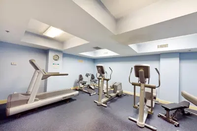 a gym with several tread machines in a room at Calypso 1-1805 by Emerald Coast Retreats in Panama City Beach