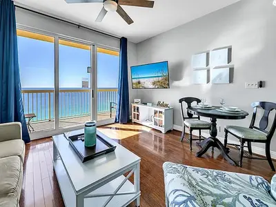 a living room with a couch and a table at Calypso 1-1805 by Emerald Coast Retreats in Panama City Beach