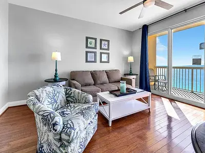 a living room with a couch and a table at Calypso 1-1805 by Emerald Coast Retreats in Panama City Beach