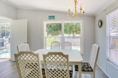 a dining room with a white table and chairs at 2 Blocks to Beach! Family-Friendly Home in PCB in Panama City Beach