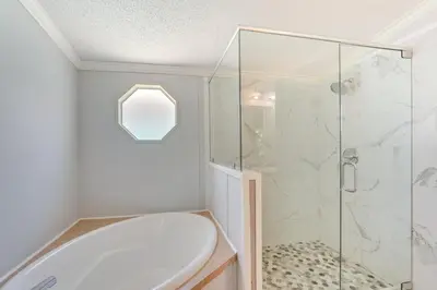 a bathroom with a shower and a white tub at 2 Blocks to Beach! Family-Friendly Home in PCB in Panama City Beach