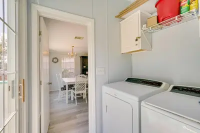 a laundry room with a washer and dryer next to a door at 2 Blocks to Beach! Family-Friendly Home in PCB in Panama City Beach