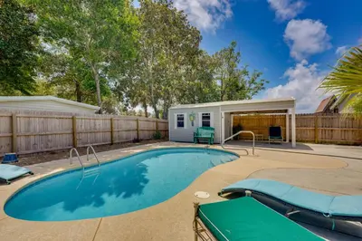 a swimming pool in a backyard with a fence at 2 Blocks to Beach! Family-Friendly Home in PCB in Panama City Beach