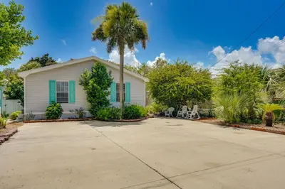 a house with a palm tree in the driveway at 2 Blocks to Beach! Family-Friendly Home in PCB in Panama City Beach