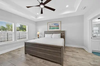 a bedroom with a bed and a ceiling fan at New Construction - West End PCB - Gated Neighborhood - FLPCB63 in Panama City Beach