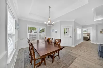 a dining room with a wooden table and chairs at New Construction - West End PCB - Gated Neighborhood - FLPCB63 in Panama City Beach