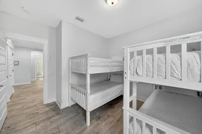 a bedroom with two bunk beds and a hallway at New Construction - West End PCB - Gated Neighborhood - FLPCB63 in Panama City Beach