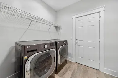 a washer and dryer in a room with a door at New Construction - West End PCB - Gated Neighborhood - FLPCB63 in Panama City Beach