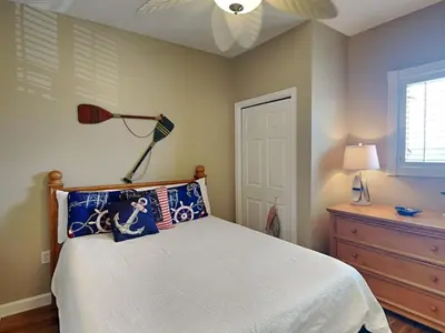 a bedroom with a bed and a ceiling fan at Sterling Reef #106 in Panama City Beach