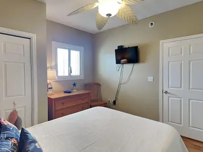 a bedroom with a bed and a ceiling fan at Sterling Reef #106 in Panama City Beach