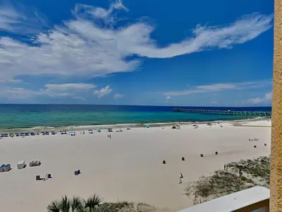 a view of a beach with chairs and the ocean at Sterling Reef #106 in Panama City Beach