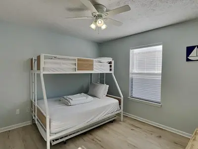 a bedroom with a bunk bed with a ceiling fan at Captain Bennetts Cove in Panama City Beach