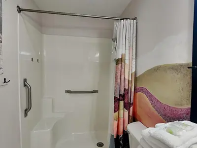 a bathroom with a shower with a shower curtain at Captain Bennetts Cove in Panama City Beach