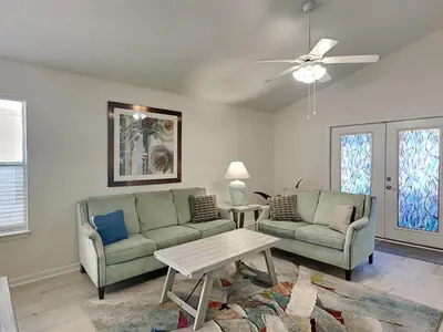 a living room with two couches and a table at Captain Bennetts Cove in Panama City Beach