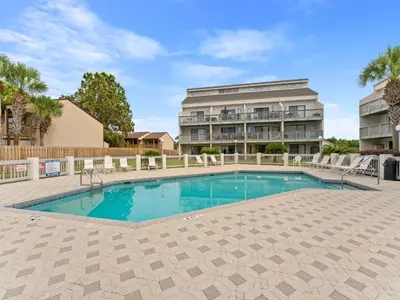 a swimming pool in front of a building at Endless Summer #A30 in Panama City Beach
