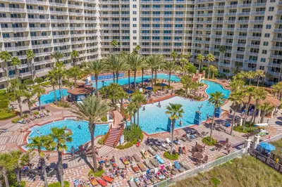 an aerial view of a resort pool with palm trees at Beachfront, Ocean Views, Sleeps 6 , Hot tub in Panama City Beach