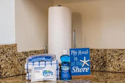 a roll of paper towels and a bottle of water on a counter at 402 Cassine Station - High Tide 30A in Santa Rosa Beach
