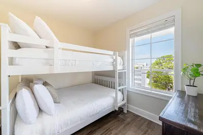 a bedroom with two bunk beds and a window at 402 Cassine Station - High Tide 30A in Santa Rosa Beach