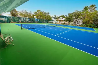 an image of a tennis court with a bench on it at 402 Cassine Station - High Tide 30A in Santa Rosa Beach