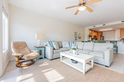 a living room with a couch and a chair at 402 Cassine Station - High Tide 30A in Santa Rosa Beach