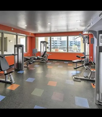 a gym with several treadmills and chairs in a room at SHORES of PANAMA 315 in Panama City Beach