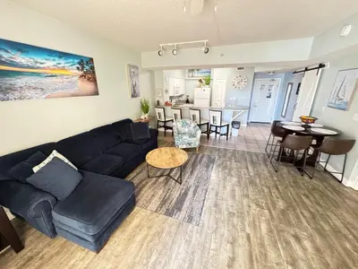 a living room with a couch and a dining room at SHORES of PANAMA 315 in Panama City Beach