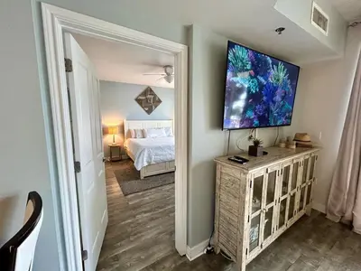 a bedroom with a bed and a flat screen tv on a wall at SHORES of PANAMA 315 in Panama City Beach