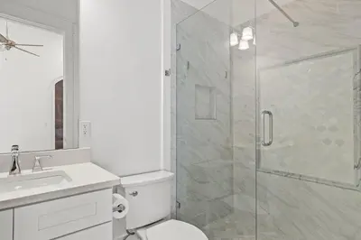 a bathroom with a shower and a toilet and a sink at Sea Esta Villa in Santa Rosa Beach
