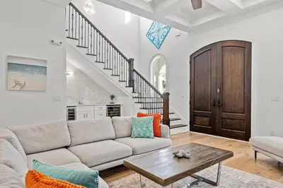 a living room with a couch and a table at Sea Esta Villa in Santa Rosa Beach