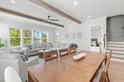 a living room with a table and a couch at The Suite Life on 30A in Santa Rosa Beach