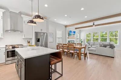 a kitchen and living room with a table and chairs at The Suite Life on 30A in Santa Rosa Beach