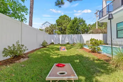 a backyard with a ping pong table in the grass at The Suite Life on 30A in Santa Rosa Beach