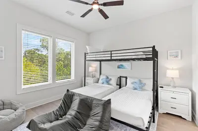 a bedroom with a bed and a ceiling fan at The Suite Life on 30A in Santa Rosa Beach
